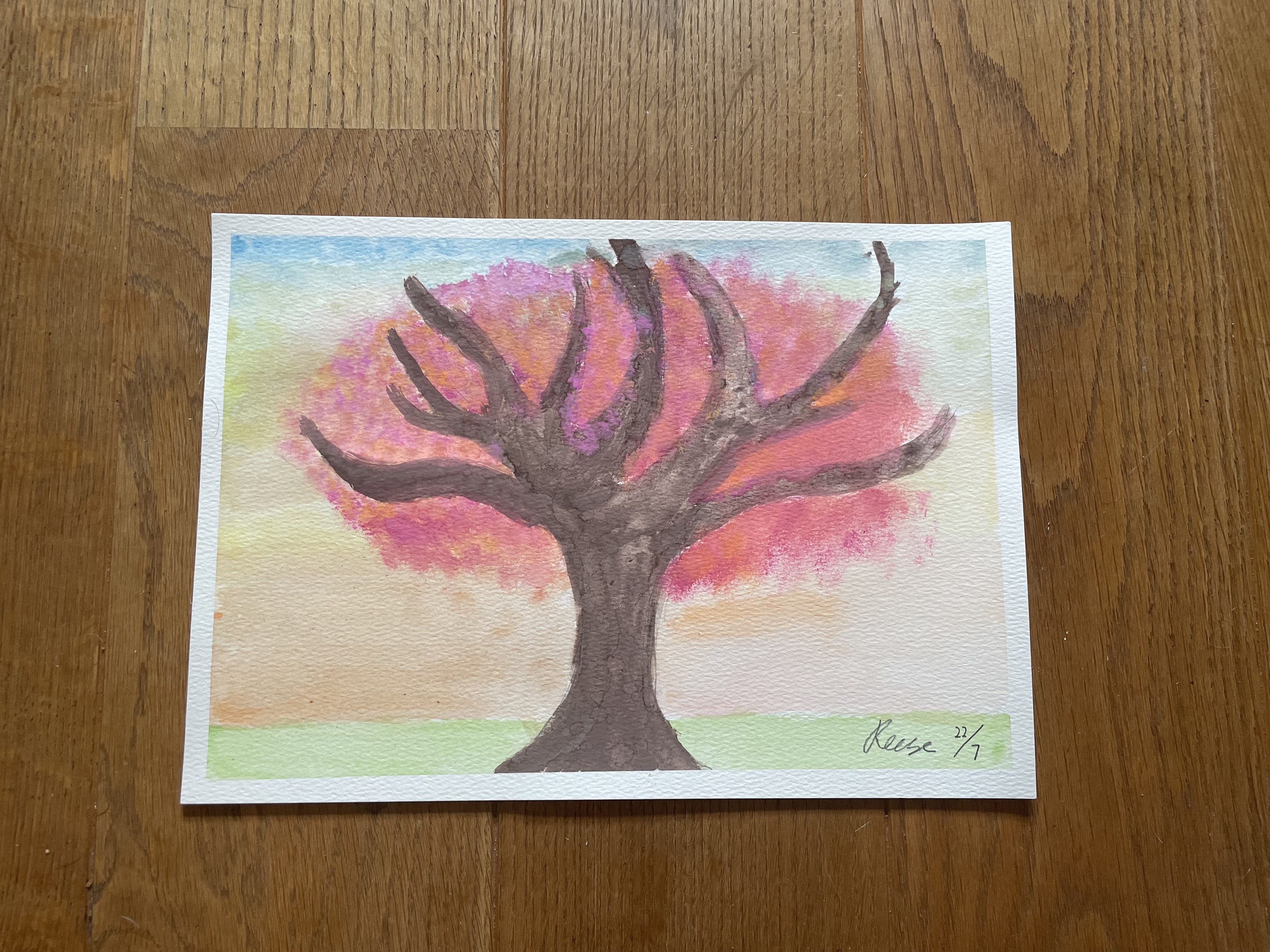 Painting of a tree dominating the park. Foliage is red and orange with an orange wash background fading to blue at the top of the picture.